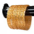 Golden yellow bangles on white background