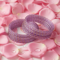 Lavender bangles on pink rose background