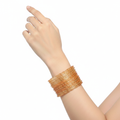 Peach raindrop glass bangles on wrist