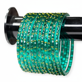 Dark seafoam green bangles on white background