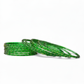 Green bangles on white background
